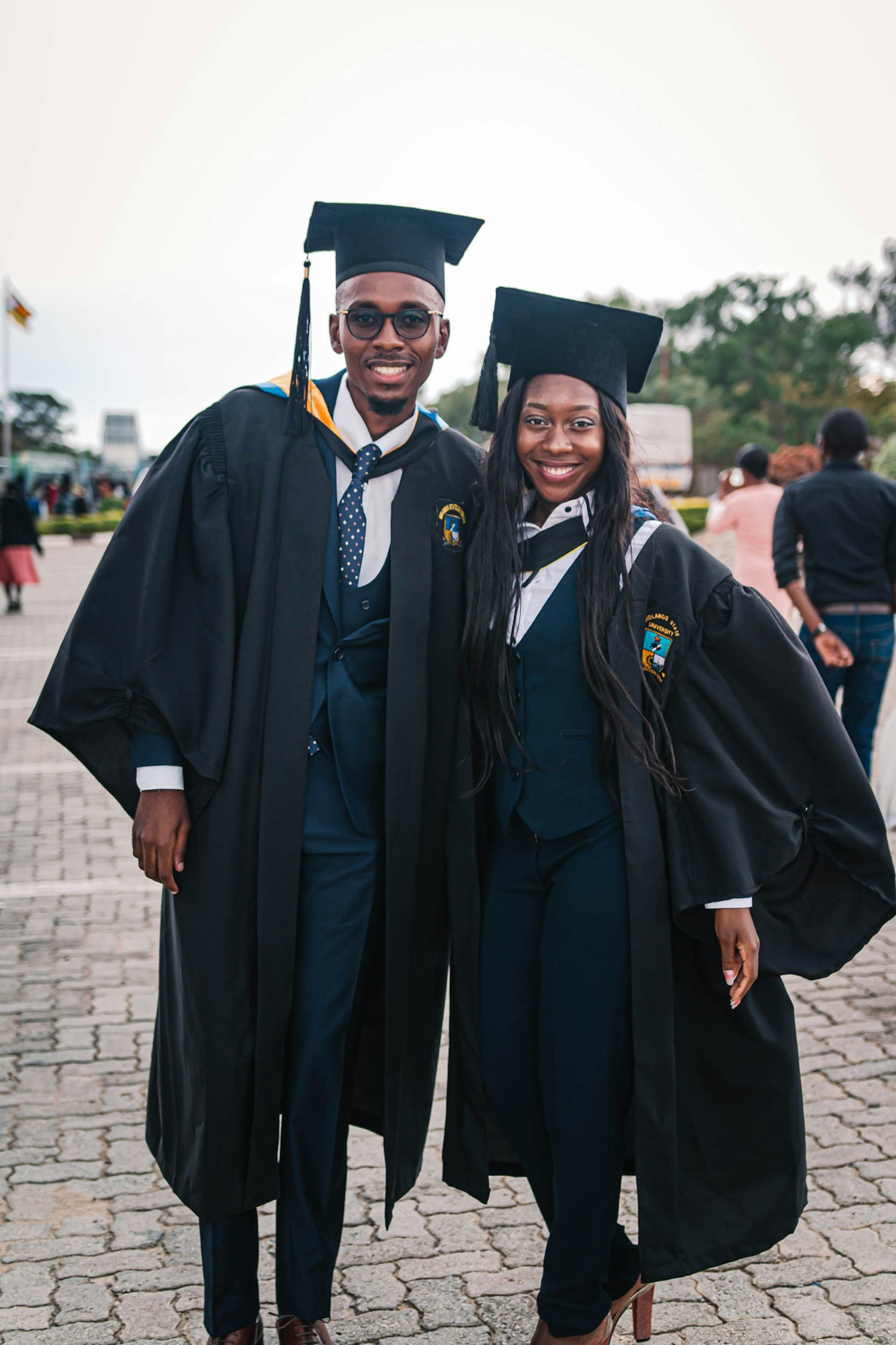 Two smiling graduates celebrating their academic achievement